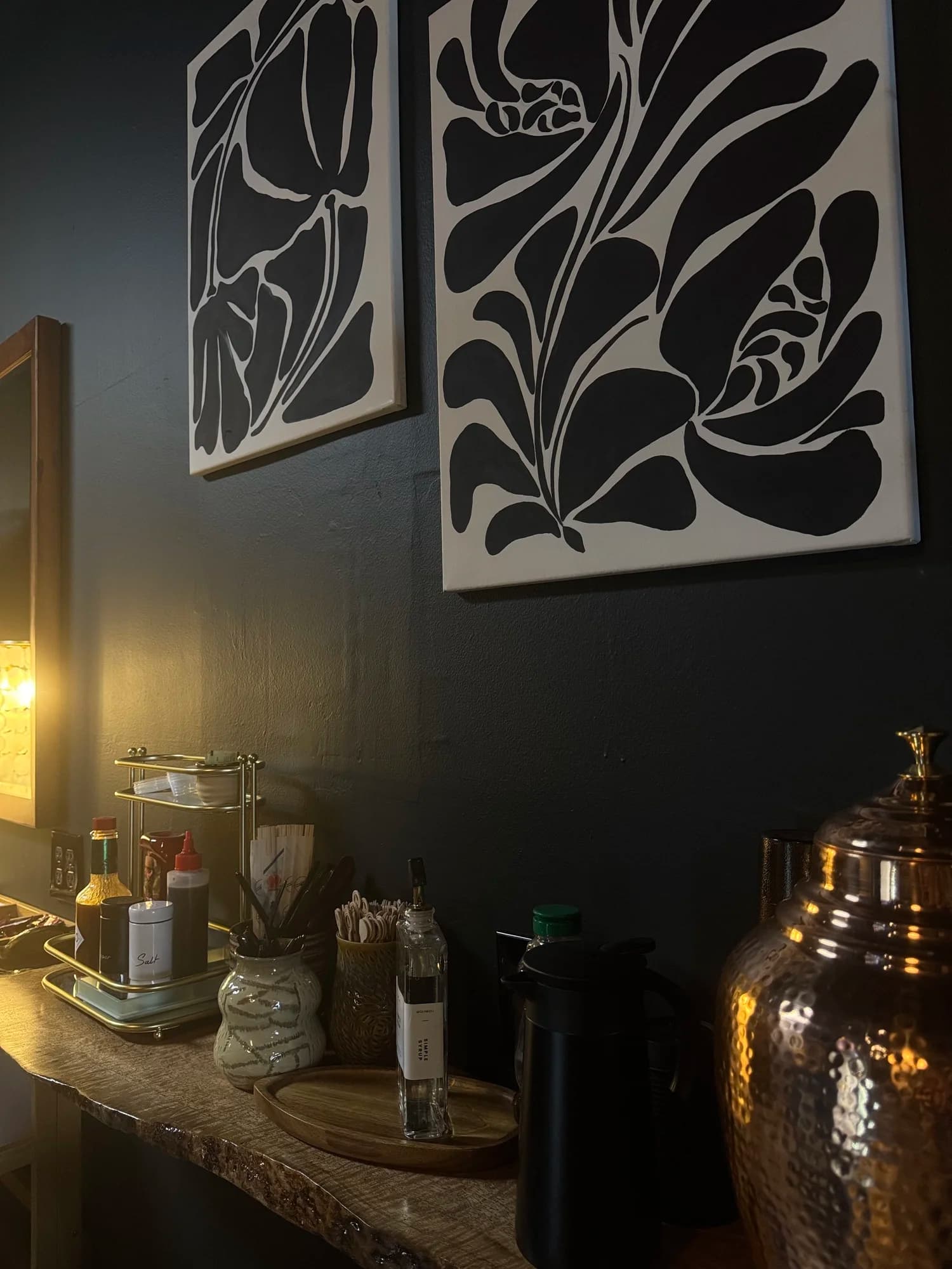 Framed black and white botanical prints from local artists on the shop wall