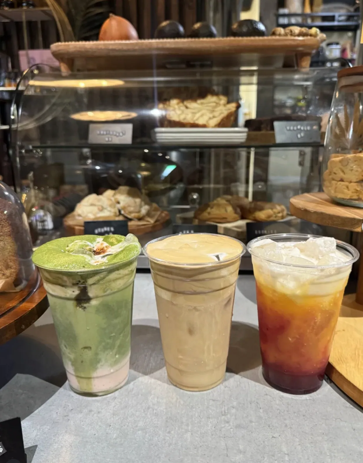 A trio of drinks and goods arranged on the counter inside the lounge