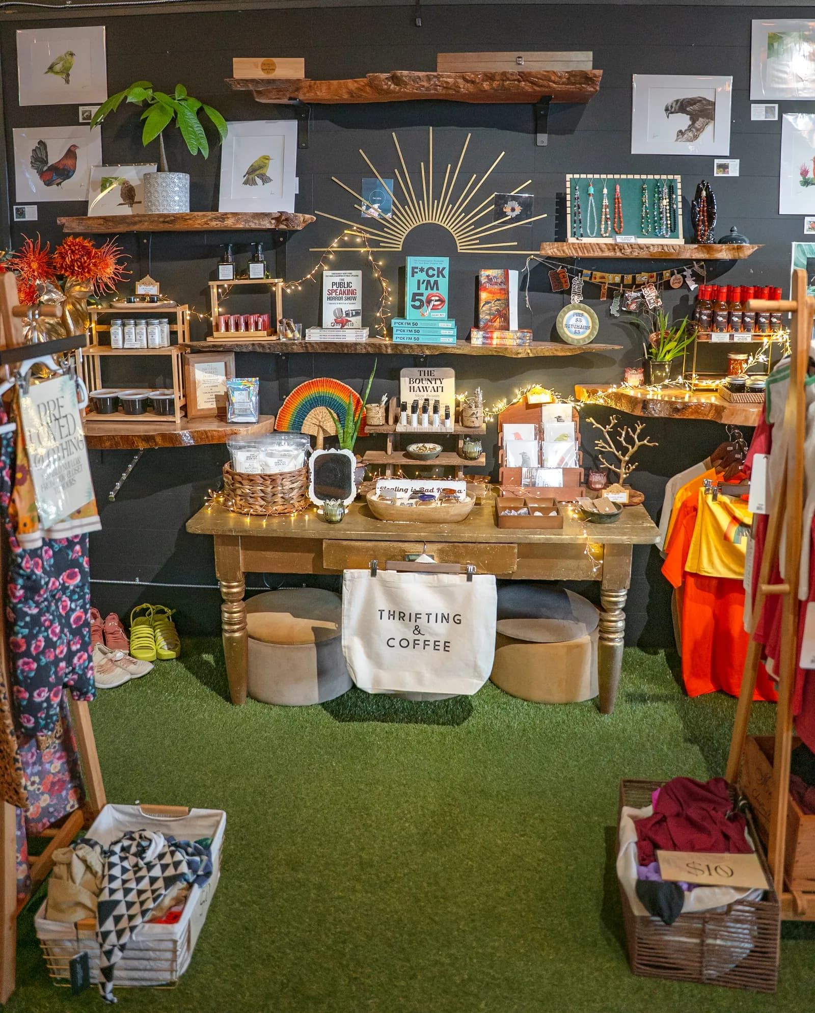 The maker's corner at Ānuenue, with local art, jewelry, house-made goods, and a curated clothing rack